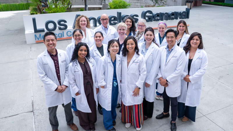 Group of Medical Students in white lab coats in front of the Los Angeles General Medical Center Sign