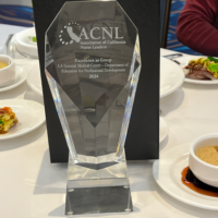 250227~1 Crystal trophy for the Excellence as group award, sitting on a table with a white tablecloth