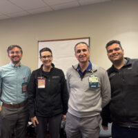 Doctors standing together and smiling at the camera