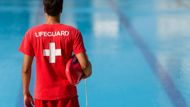 Lifeguard watching swimming pool
