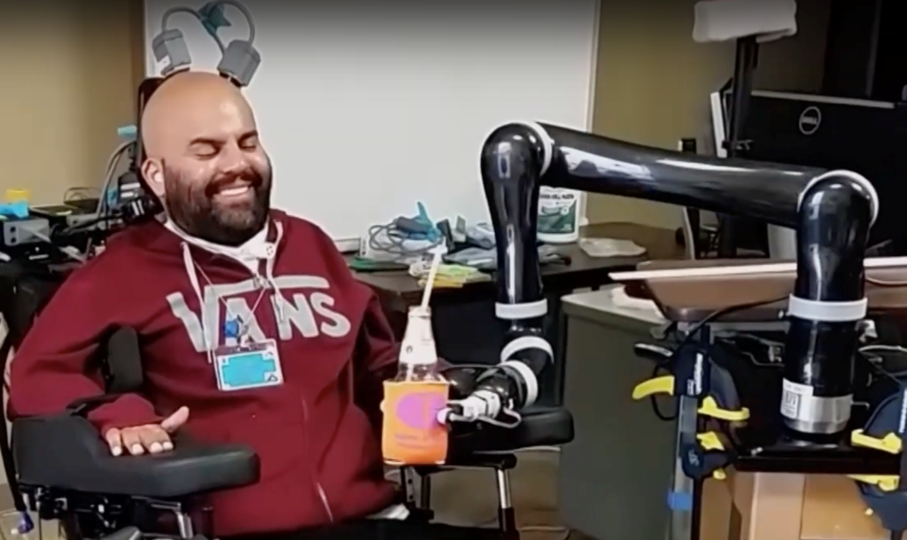 Rancho Los Amigos patient Erik Sorto, who is a quadriplegic, successfully manipulating a robot arm to bring a drink to his face
