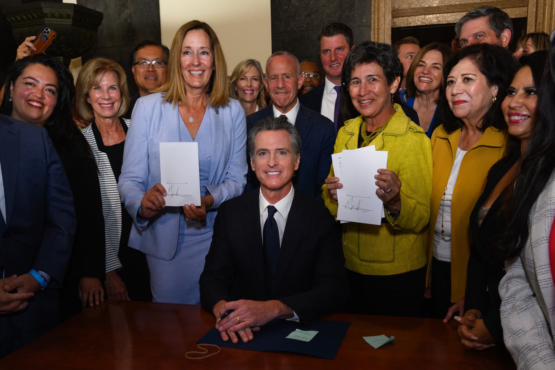 Governor Gavin Newsom with bill author CA Assemblymember District 42 Jacqui Irwin (in blue) and co-sponsor Susan Eggman - CA Senator District 5 (in yellow). Also in attendance were First District Supervisor Hilda Solis and Fourth District Supervisor Janice Hahn.