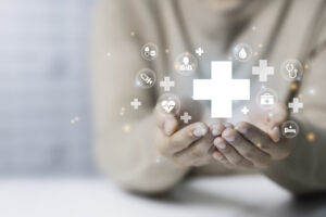 Woman hand holding plus icon for the healthcare medical icon. Health insurance concept. Benefits and Access to welfare health, doctors, hospitals, treatment with copy space